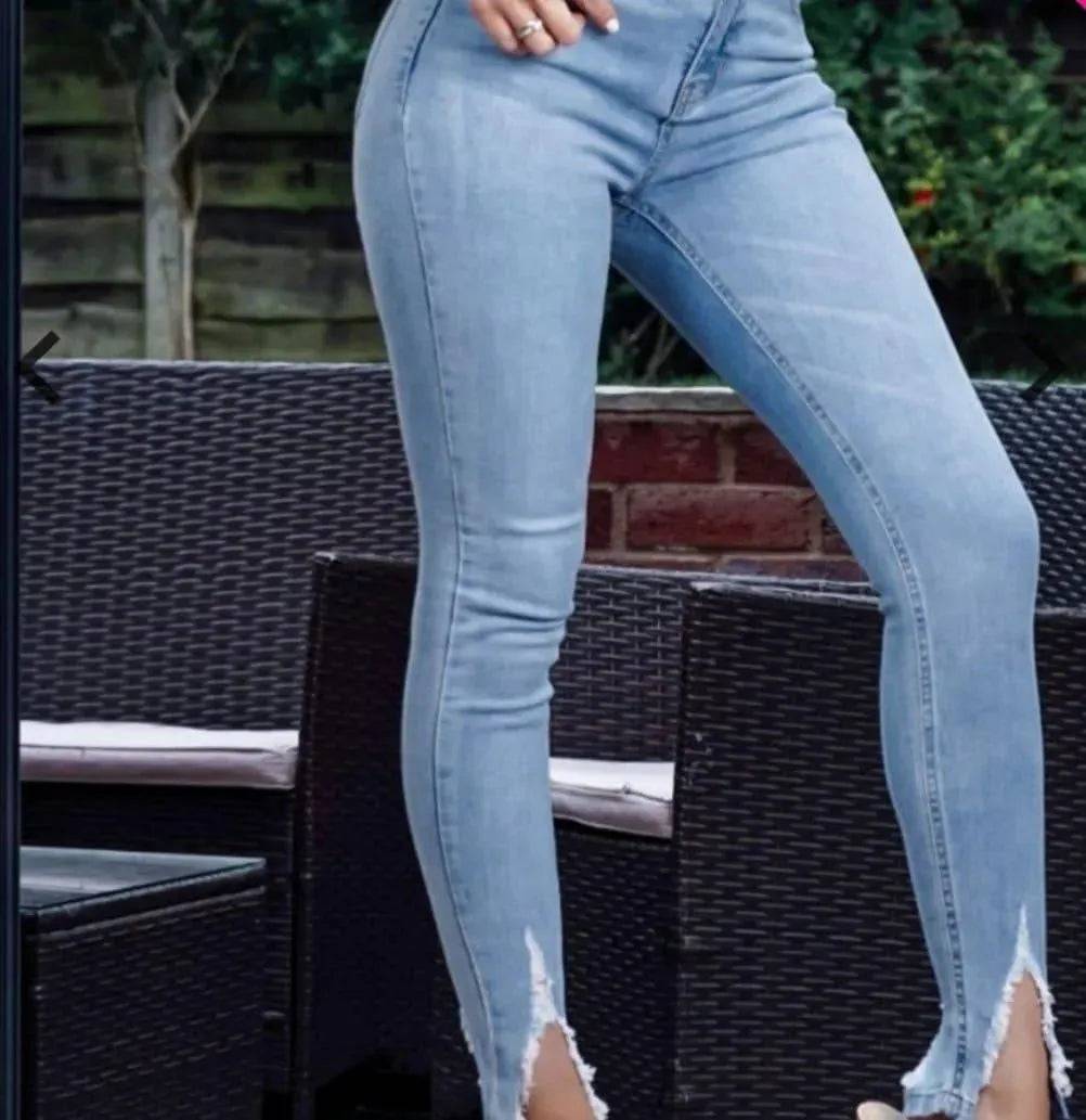 Light blue distressed split jeans by My Sexy Black Boutique, showcasing ripped details and casual fit.