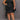 My Sexy Black Carolyn Plus Size Mini Dress displayed on a hanger, featuring a stylish, fitted design for plus size fashion.
