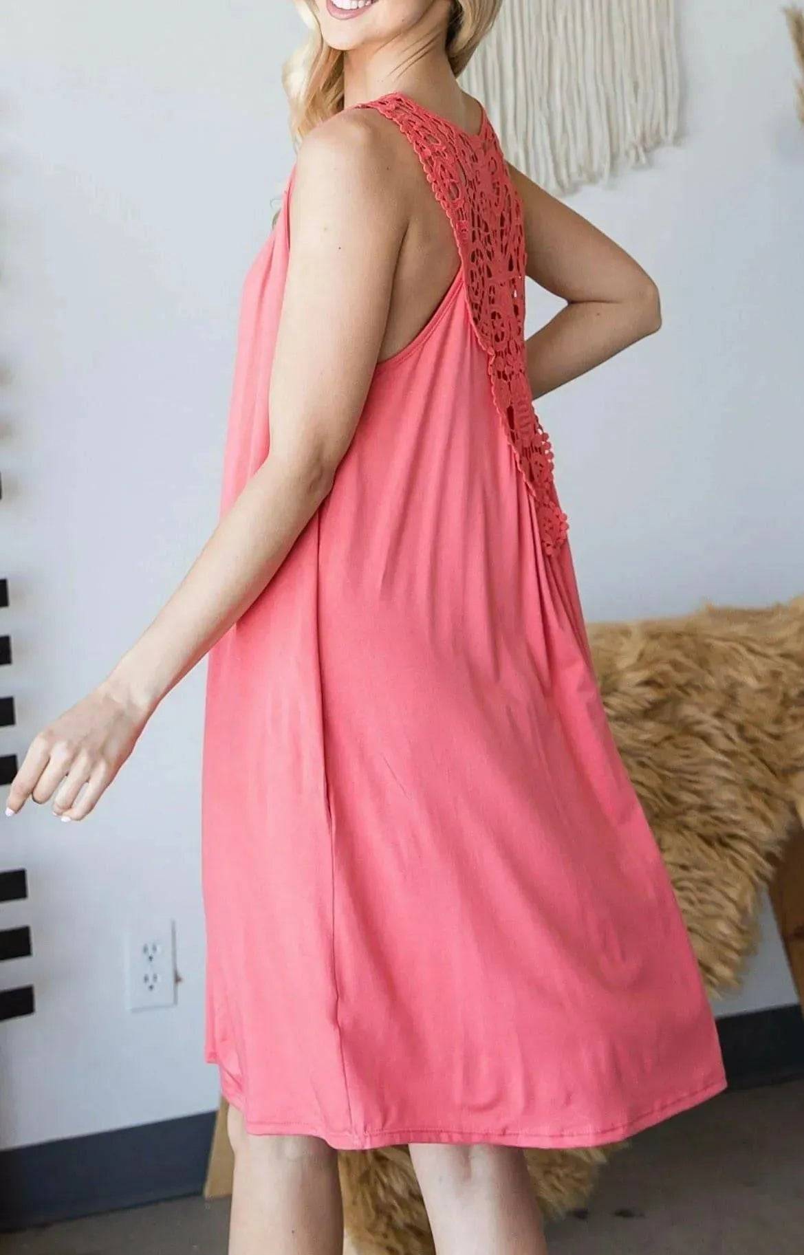 Side view of coral Sally Crochet Mini Dress highlighting soft fabric and lace back detail, perfect for casual and feminine street style.