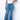 Medium wash blue slit jeans from My Sexy Black Boutique, featuring stylish side slits and a classic denim fit.