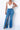 Medium wash blue slit jeans from My Sexy Black Boutique, featuring stylish side slits and a classic denim fit.