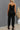 See Me Split-Black jumpsuit from My Sexy Black Boutique featuring a stylish split design and sleeveless fit.