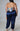 Plus size summer two-piece set with black bandeau top and high-waisted leggings, worn by a girl outdoors.